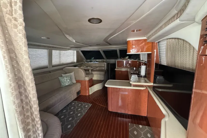 Scanner II Yacht Photos Pics Luxurious interior of a 1998 Sea Ray 480 Sedan Bridge yacht with elegant wood finishes.