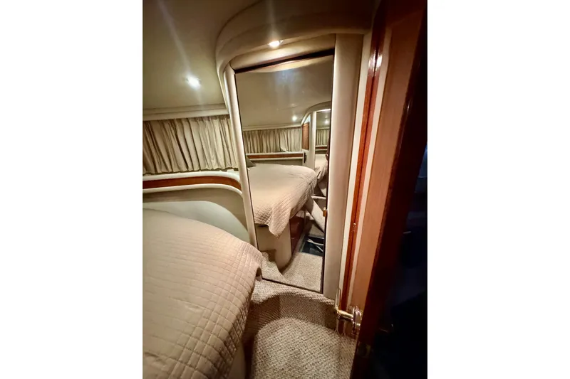Scanner II Yacht Photos Pics Interior cabin of 1998 Sea Ray 480 Sedan Bridge yacht with cozy bedding.