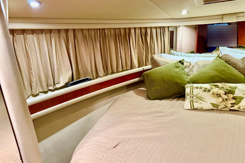Scanner II Yacht Photos Pics Interior cabin of 1998 Sea Ray 480 Sedan Bridge with cozy bedding and curtains.