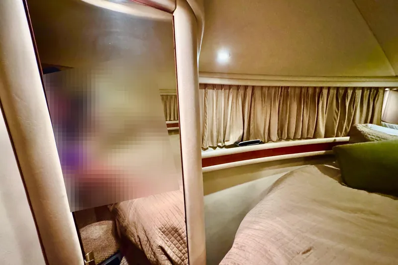 Scanner II Yacht Photos Pics 1998 Sea Ray 480 Sedan Bridge cabin interior with cozy bedding and curtains.