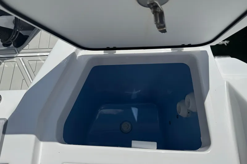  Yacht Photos Pics Open storage compartment on 2024 Blackfin 332 CC boat, featuring a blue interior.