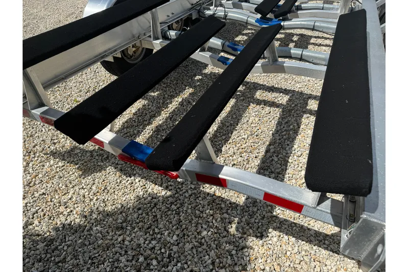  Yacht Photos Pics Boat trailer for 2024 Blackfin 332 CC on gravel surface.