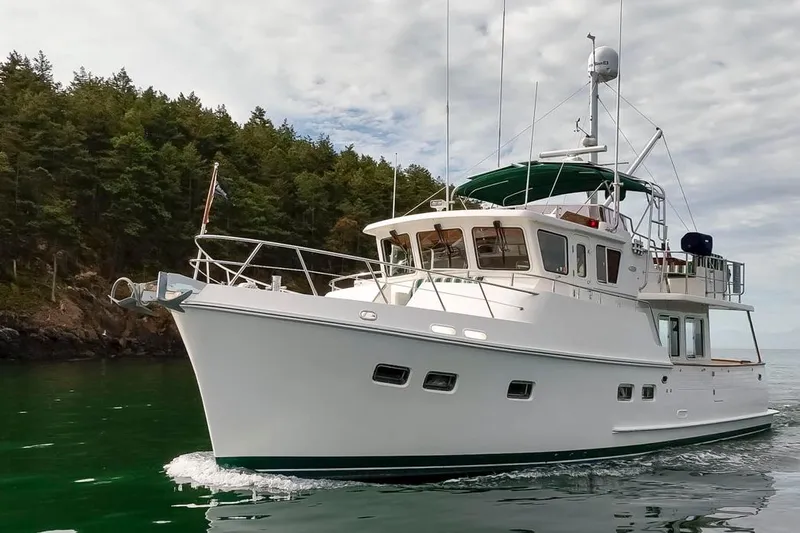 Forever Young Yacht Photos Pics Luxury 2009 Selene 43 yacht cruising near forested shoreline.