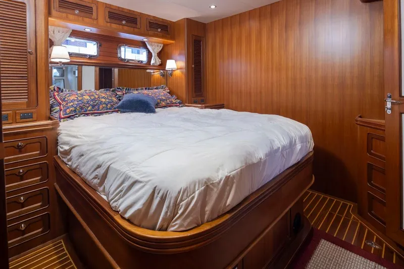 Forever Young Yacht Photos Pics Luxurious wooden cabin interior of 2009 Selene 43 yacht with cozy bed and elegant decor.