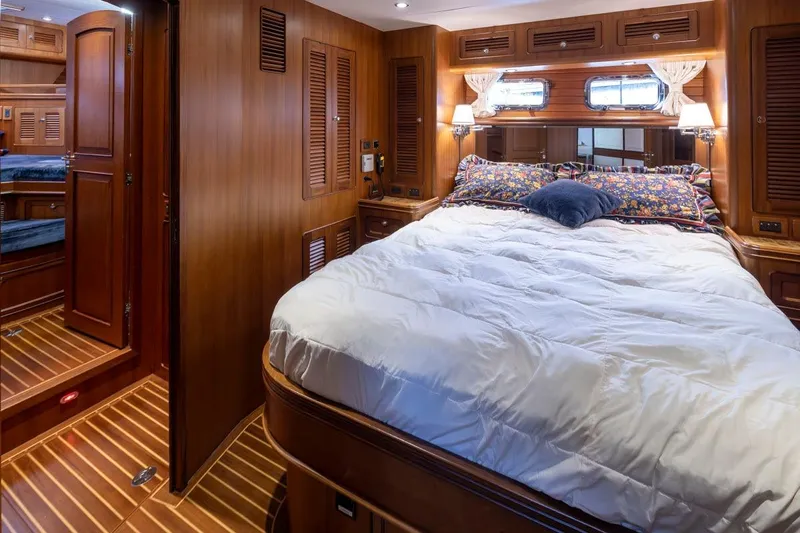 Forever Young Yacht Photos Pics Luxurious 2009 Selene 43 yacht bedroom with wood paneling and cozy bedding.