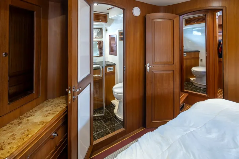 Forever Young Yacht Photos Pics Luxurious wooden interior of 2009 Selene 43 yacht cabin with ensuite bathroom.