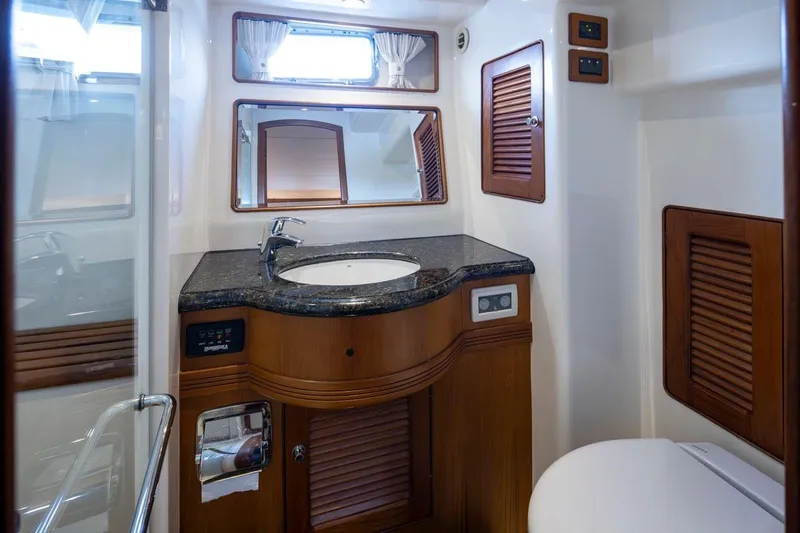 Forever Young Yacht Photos Pics Luxurious bathroom interior of 2009 Selene 43 yacht with wooden accents and modern fixtures.