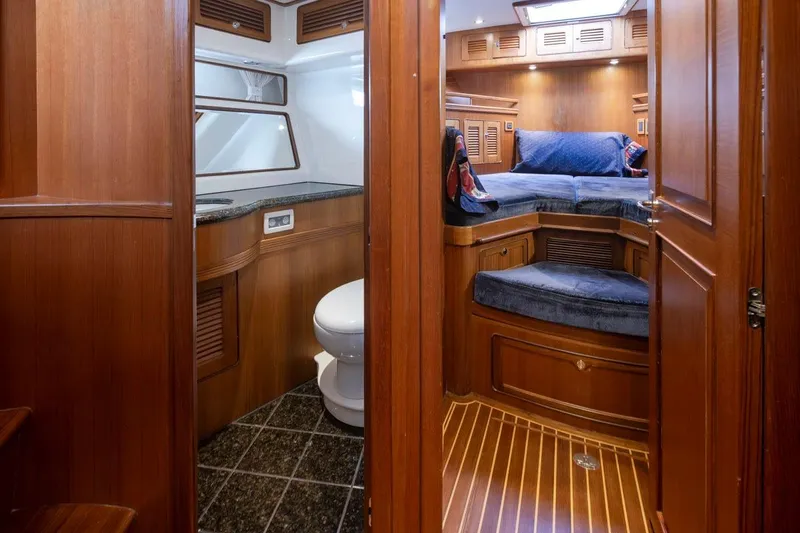 Forever Young Yacht Photos Pics Luxurious 2009 Selene 43 yacht interior with wood finish, cozy cabin, and modern amenities.