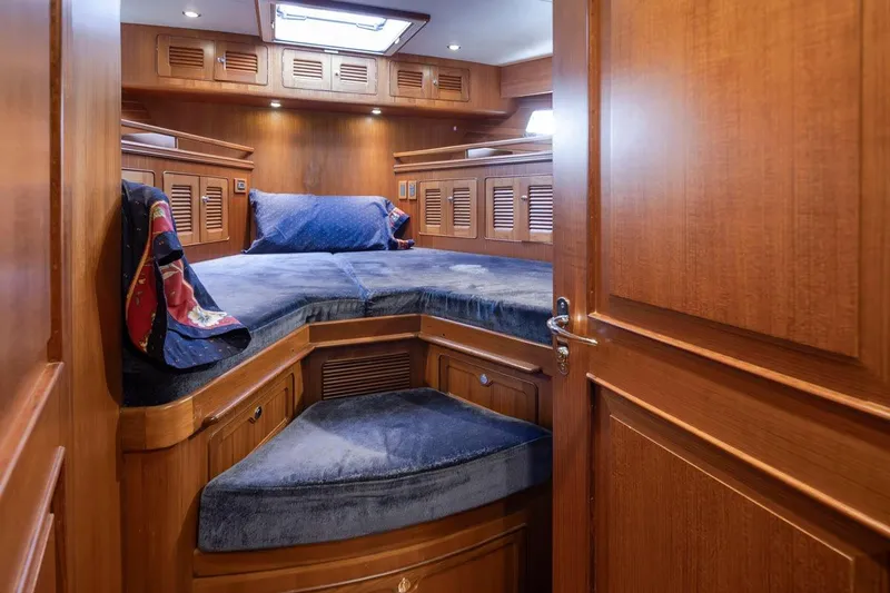 Forever Young Yacht Photos Pics Luxurious wooden cabin interior of 2009 Selene 43 yacht with cozy bedding.