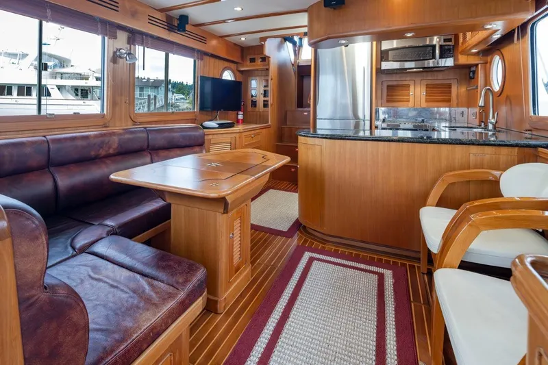 Forever Young Yacht Photos Pics Luxurious interior of 2009 Selene 43 yacht with leather seating and modern kitchen.