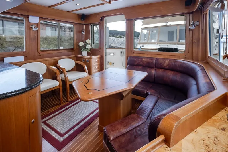 Forever Young Yacht Photos Pics Luxurious interior of 2009 Selene 43 yacht with elegant wood and leather seating.