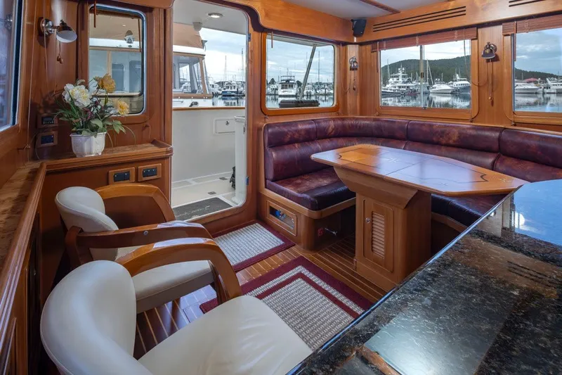 Forever Young Yacht Photos Pics Luxurious interior of 2009 Selene 43 yacht with elegant wood finishes and marina view.