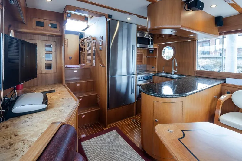 Forever Young Yacht Photos Pics Luxurious 2009 Selene 43 yacht interior with modern kitchen and elegant wood finishes.