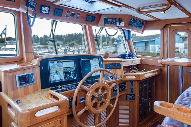 Forever Young Yacht Photos Pics Luxurious 2009 Selene 43 yacht helm with advanced navigation systems and wooden interior.