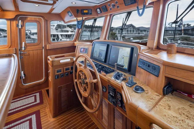 Forever Young Yacht Photos Pics Luxurious 2009 Selene 43 yacht helm with wooden interior and advanced navigation systems.