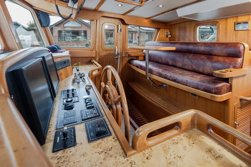 Forever Young Yacht Photos Pics Luxurious 2009 Selene 43 yacht interior with wooden helm and leather seating.