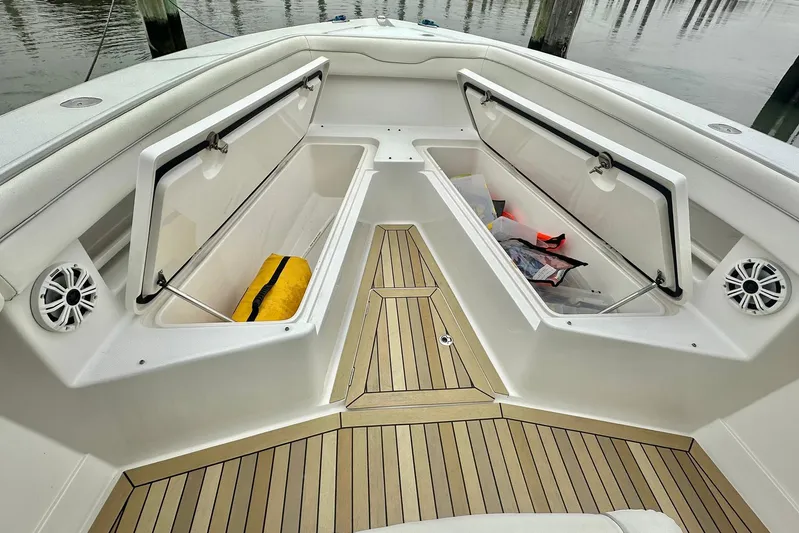 Warden Pass Too Yacht Photos Pics 2013 Jupiter 30 Center Console boat with open storage compartments and teak flooring.