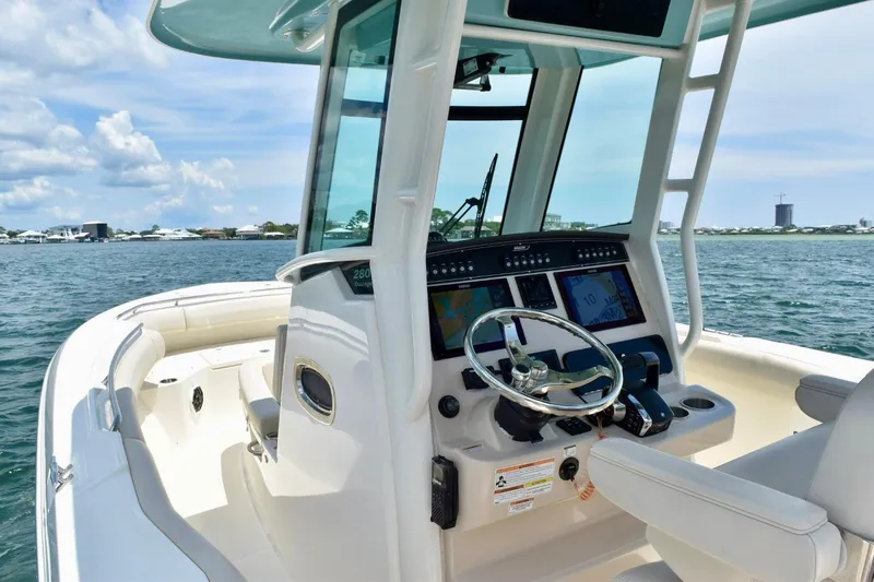  Yacht Photos Pics 2023 Boston Whaler 280 Outrage boat interior with modern helm and ocean view.
