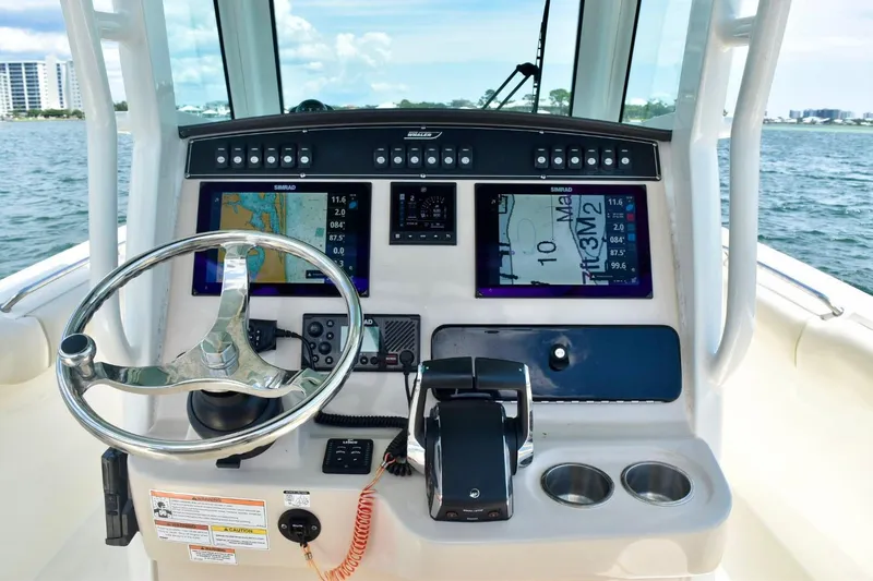  Yacht Photos Pics 2023 Boston Whaler 280 Outrage helm with advanced navigation displays and controls.
