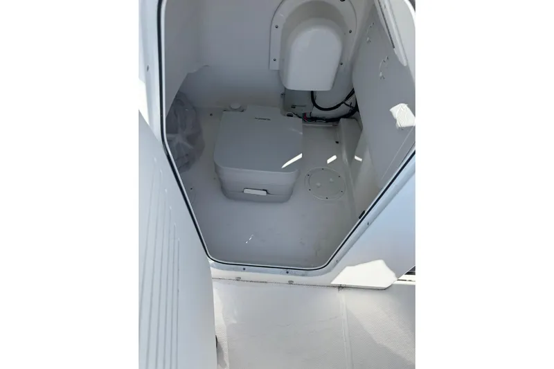  Yacht Photos Pics 2024 Everglades 243 Center Console interior with compact marine toilet.