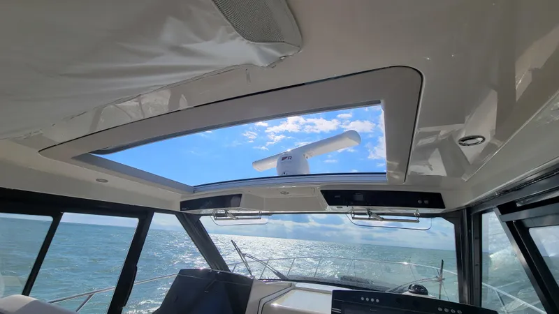 Yacht Photos Pics Interior view of 2021 Boston Whaler 405 Conquest with ocean and sky visible through sunroof.