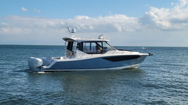  Yacht Photos Pics 2021 Boston Whaler 405 Conquest boat cruising on open water under a cloudy sky.