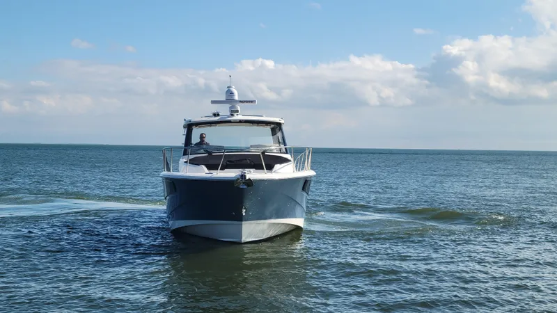  Yacht Photos Pics Boston Whaler 405 Conquest 2021 cruising on open water under a clear sky.