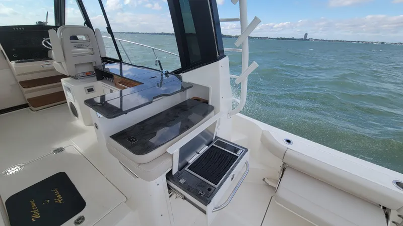  Yacht Photos Pics 2021 Boston Whaler 405 Conquest boat interior with ocean view and fishing station.