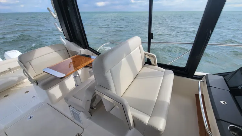  Yacht Photos Pics 2021 Boston Whaler 405 Conquest interior with beige seating and ocean view.