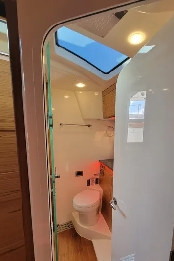  Yacht Photos Pics Interior view of 2021 Boston Whaler 405 Conquest bathroom with modern fixtures and skylight.