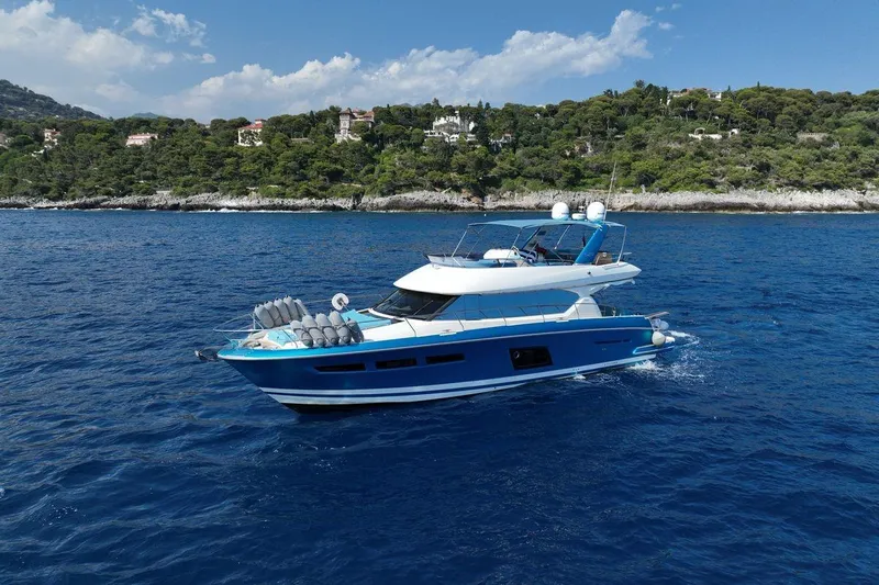 Grace Yacht Photos Pics Prestige 620 yacht cruising on blue ocean near scenic coastline, 2013 model.