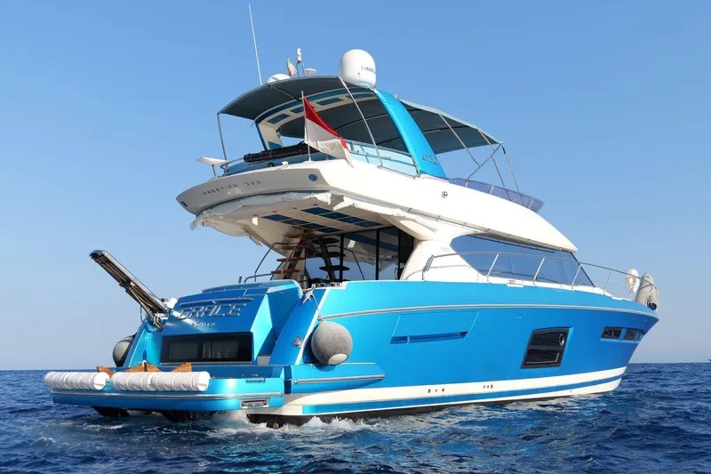 Grace Yacht Photos Pics Luxurious 2013 Prestige 620 yacht cruising on open sea, vibrant blue exterior.