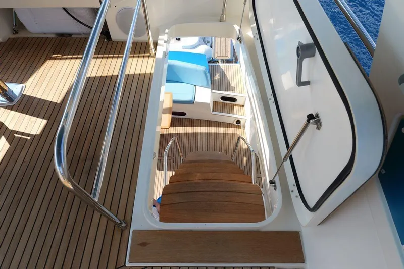 Grace Yacht Photos Pics Staircase on 2013 Prestige 620 yacht with wooden steps and metal railings.