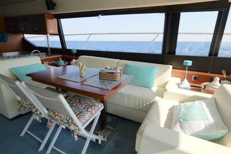 Grace Yacht Photos Pics Luxurious interior of 2013 Prestige 620 yacht with ocean view, featuring elegant seating and dining area.