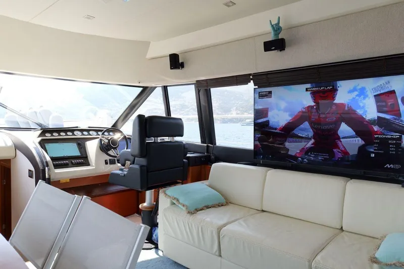 Grace Yacht Photos Pics Luxurious interior of 2013 Prestige 620 yacht with helm and large TV screen.