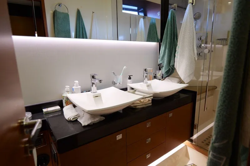 Grace Yacht Photos Pics Luxurious bathroom in a 2013 Prestige 620 yacht with dual sinks and modern fixtures.