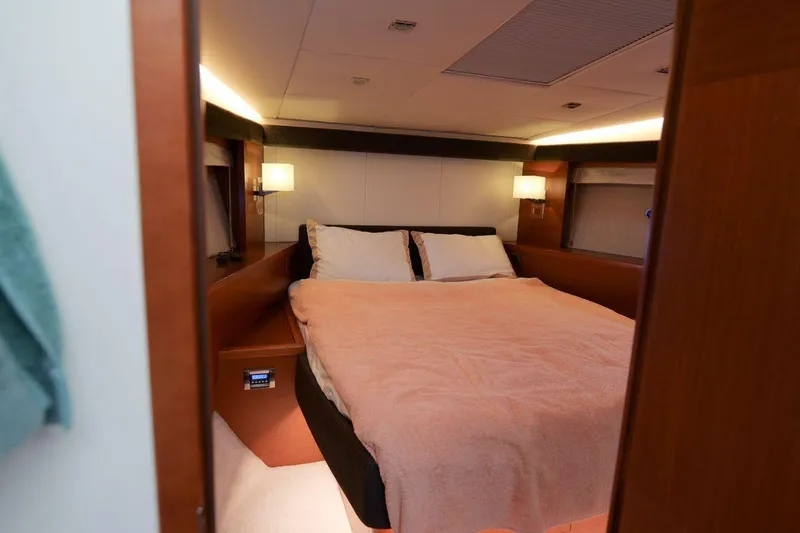 Grace Yacht Photos Pics Luxurious bedroom interior of 2013 Prestige 620 yacht with cozy lighting and elegant design.