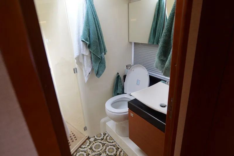 Grace Yacht Photos Pics Bathroom interior of 2013 Prestige 620 yacht with modern fixtures and towels.