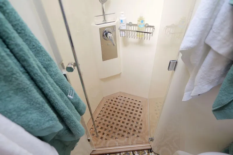 Grace Yacht Photos Pics Shower area in 2013 Prestige 620 yacht with glass door and wooden floor.