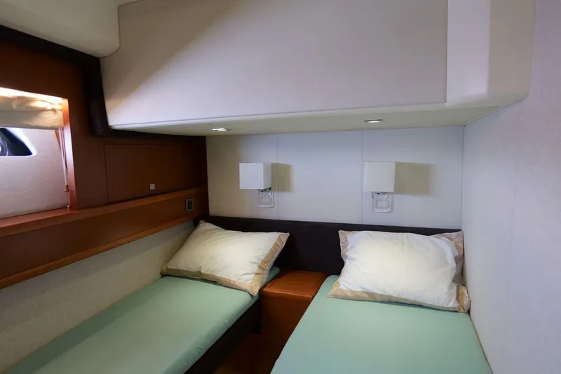 Grace Yacht Photos Pics Interior of 2013 Prestige 620 yacht cabin with twin beds and modern lighting.