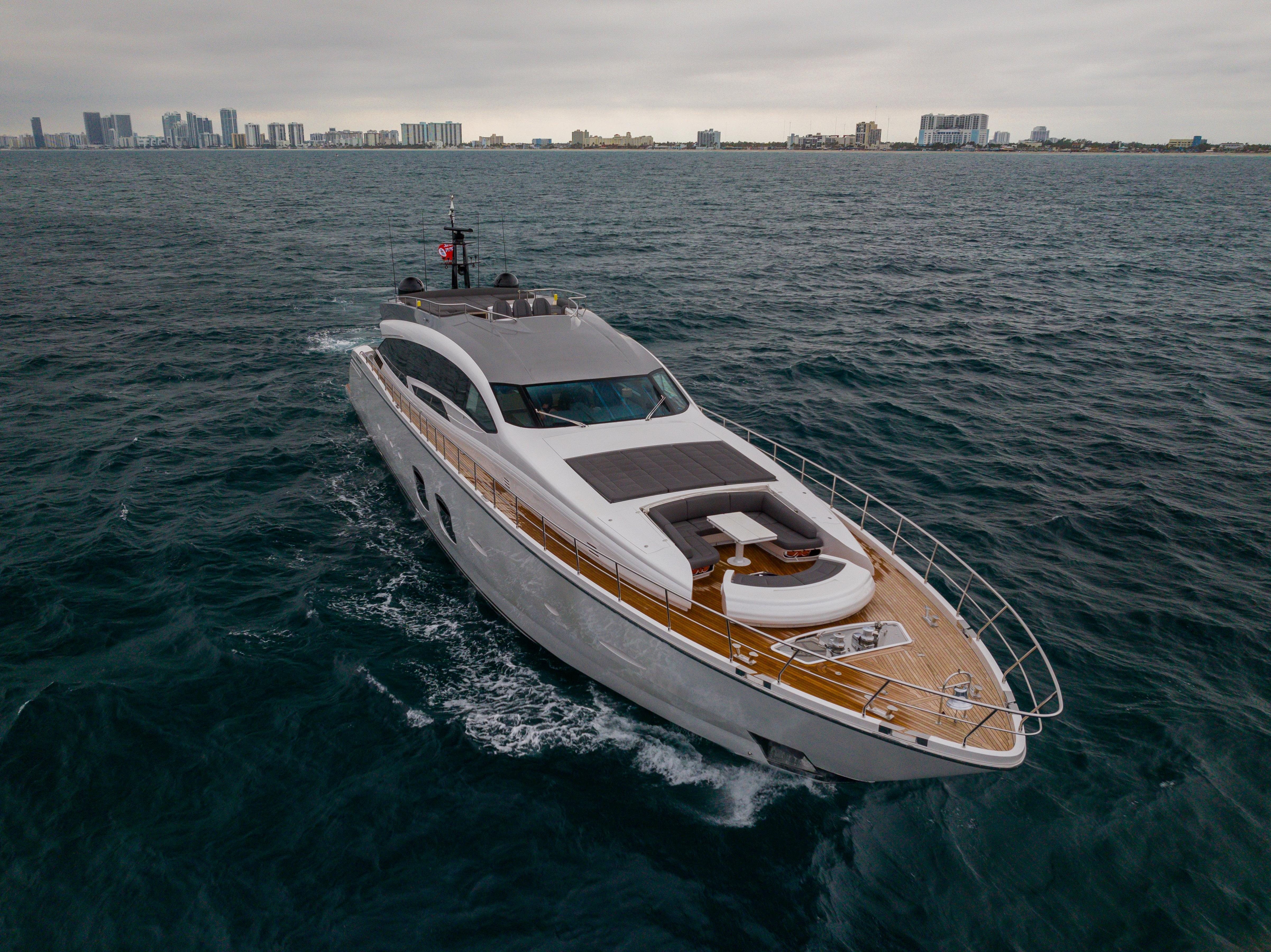 Luxury 2018 Pershing 108 yacht cruising on open water near city skyline.