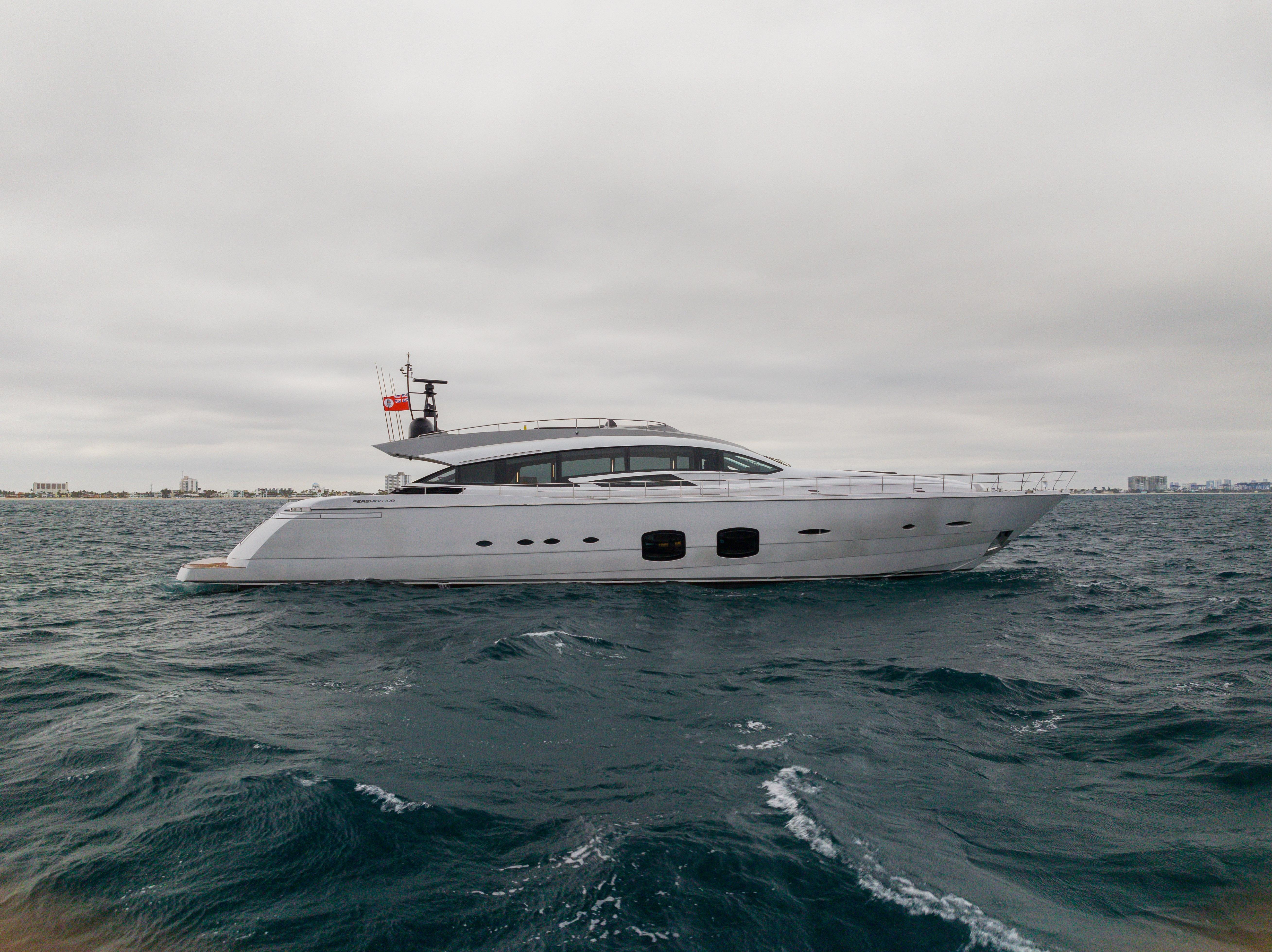 2018 Pershing 108 yacht cruising on open water under cloudy skies.
