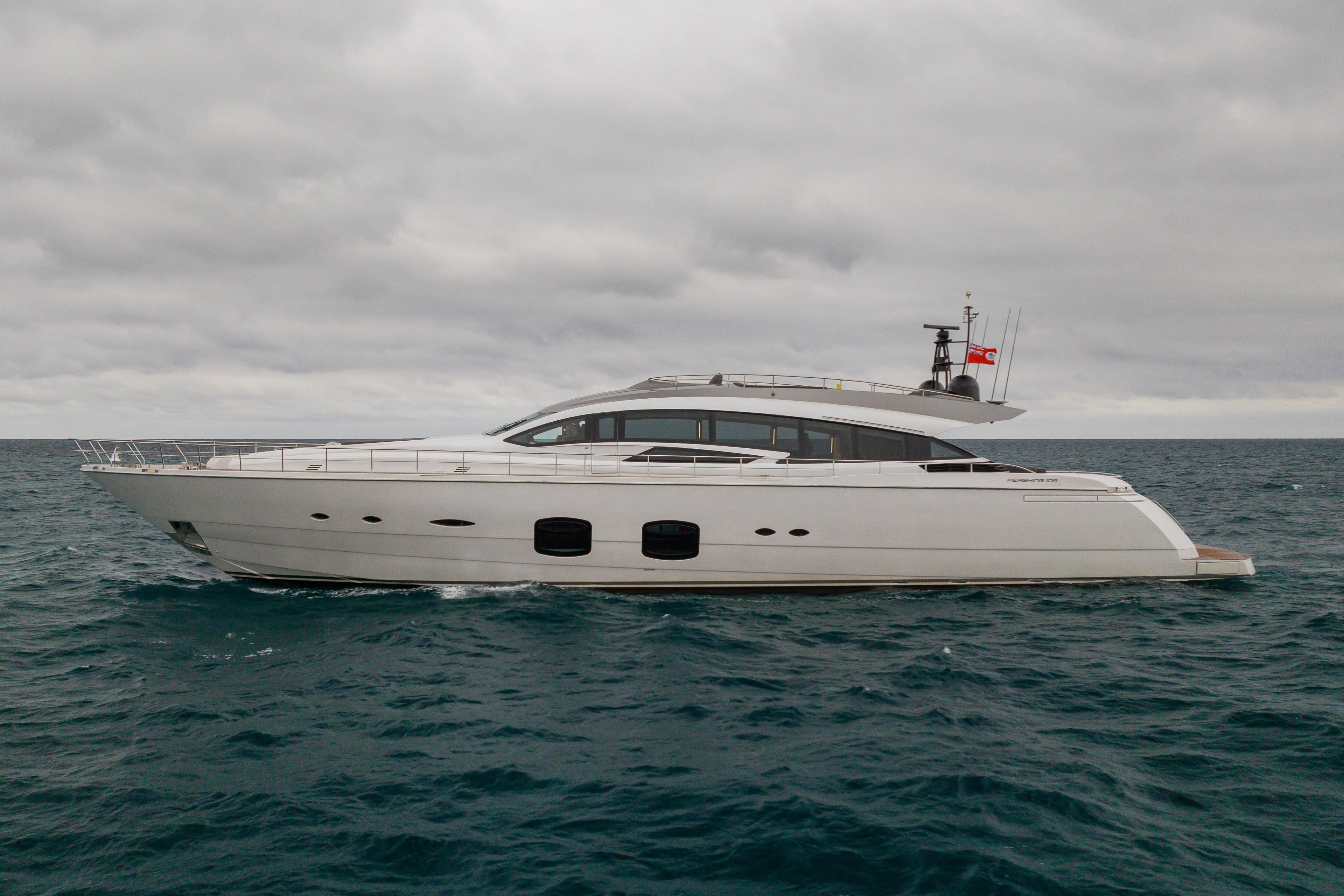 2018 Pershing 108 yacht cruising on open sea under cloudy skies.