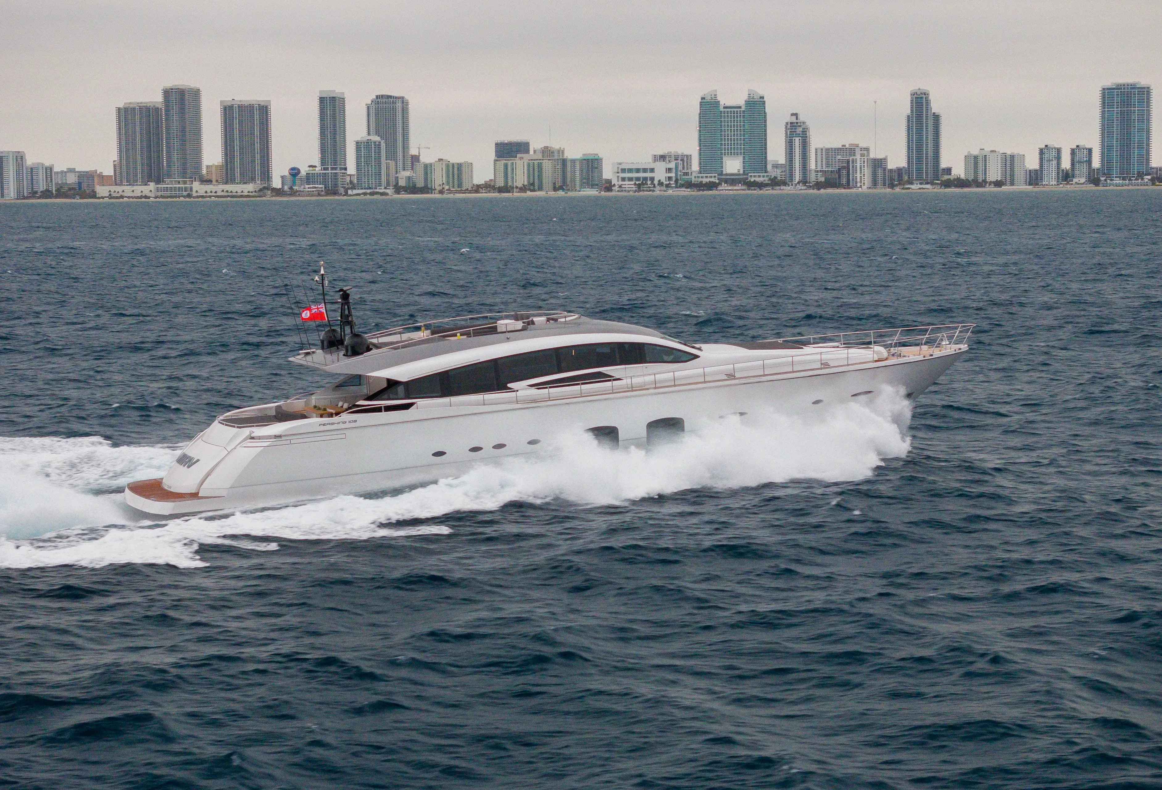 Luxury Pershing 108 yacht cruising near city skyline, 2018 model.