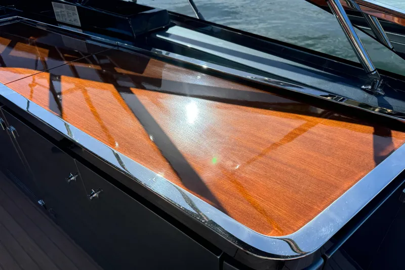  Yacht Photos Pics Polished wooden deck of 2018 Riva 56' Rivale yacht reflecting sunlight.