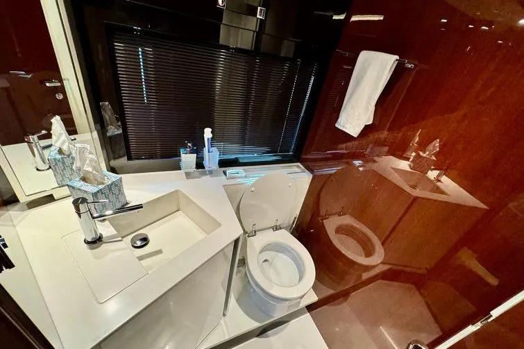  Yacht Photos Pics Luxurious bathroom in 2018 Riva 56' Rivale yacht with modern fixtures and elegant design.