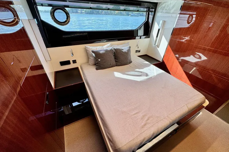  Yacht Photos Pics Luxurious bedroom interior of 2018 Riva 56' Rivale yacht with elegant wood finishes.