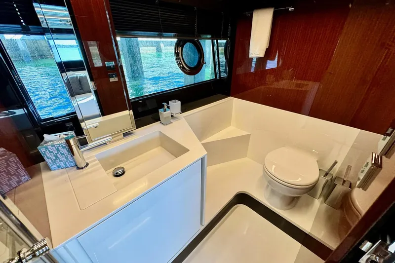  Yacht Photos Pics Luxurious bathroom in 2018 Riva 56' Rivale yacht with modern fixtures and scenic window view.