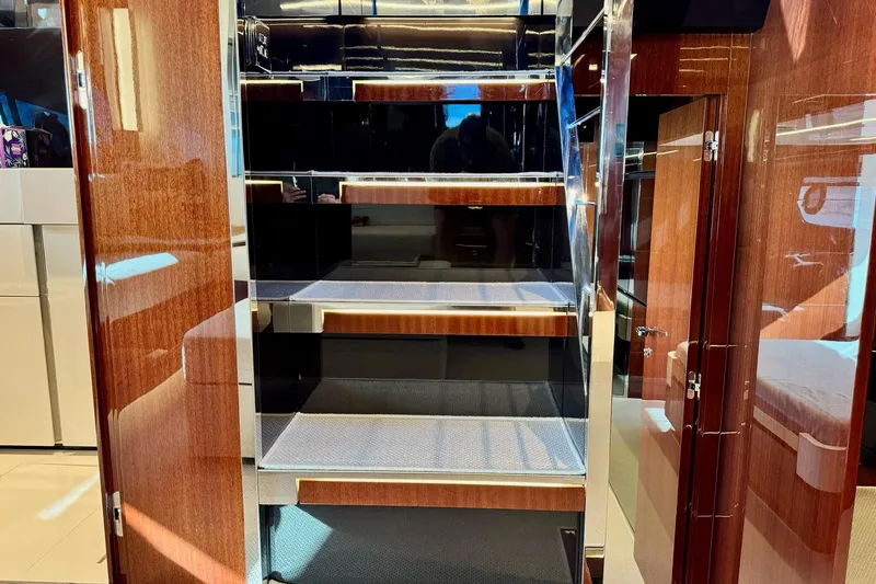  Yacht Photos Pics Luxurious interior staircase of 2018 Riva 56' Rivale yacht with glossy wood finish.