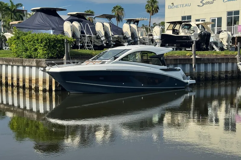  Yacht Photos Pics 2022 Beneteau Gran Turismo 32 yacht docked at a marina, surrounded by other boats.